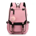 Close-up of pink student backpack with USB charging port and fluffy pom-pom detail. - Pink