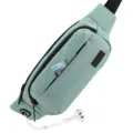 Detail view of light green sports waist bag with earphone port and front pocket - Light Green