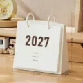 Minimalist white 2027 desktop flip calendar with size markings on a wooden desk - With Calendar Core (2026-2027) / White