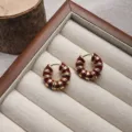 Close-up of French vintage dark red enamel hoop earrings with gold-plated ribbed design. - Red Gold