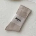 Neutral beige cotton mid-calf socks with minimal Japanese style packaging label - One Size / Light Coffee