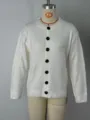 Detailed view of a white long-sleeve round-neck knitted cardigan with black buttons. - S / Tops / White