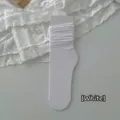 Soft white slouch socks in mid-calf length featuring a comfortable ribbed texture - One Size / White
