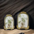 Detailed view of two French vintage resin photo frames featuring elegant floral oil paintings - 7" / Black