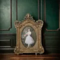 Close-up of an ornate vintage gold resin photo frame featuring a classical portrait painting - Outer Diameter: 21*28CM / Antique Gold
