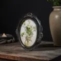 Oval vintage black resin picture frame with gold ornate carved details on wood table - 7 Inch (Outer 18*22cm)