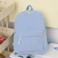 Mochila de pana azul claro con bolsillo delantero y cordones blancos decorativos - Azul