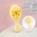 Brosse à cheveux jaune avec nœud, brosse de massage portable à coussin d'air - Peigne à Manche Nœud / Jaune