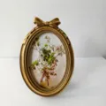 Antique gold oval resin photo frame with bow detail, perfect vintage floral wall art. - Inner 10x14.5cm Outer 13x19cm
