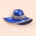 Macro view of an elegant blue sun hat brooch with sparkling crystal flower details - Blue