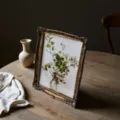 Vintage ornate resin photo frame with floral art illustration on rustic wooden table - 24*29cm / 29*33.5CM