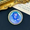 Detailed view of a vintage iridescent angel relief brooch with rhinestone border - Blue Angel Cameo / Blue