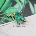 Macro view of a vintage bird brooch with green and blue enamel and shining crystals - Blue Green Gradient Bird Leaf Style (BK06)