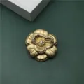 Exquisite golden baroque camellia brooch with sparkling rhinestones and matte metal finish - Matte Gold Camellia Style