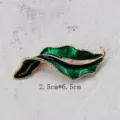 Detailed macro view of vintage green enamel leaf brooch with 2.5x6.5cm size info - Enamel Gold Edged Green Leaf Style (BK08)