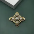 Detail view of gold baroque cross brooch with elegant pearls and sparkling rhinestones - Baroque Cross Flower Style