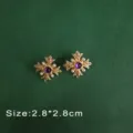 Close-up of vintage Baroque style gold cross brooch with purple gemstone and pearls - Purple Gem Cross Studs (E6)