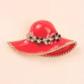 Elegant red sun hat brooch featuring sparkling rhinestones and gold-tone trim details - Red