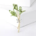 Close-up of an elegant green enamel flower bouquet brooch with sparkling butterfly rhinestone detail. - Bouquet (BR-2366) / Green