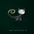 Elegant black and white enamel cat brooch with green eyes and gold-tone finish. - Black White Cat Style (V16)