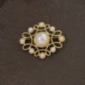 Macro view of vintage gold baroque brooch with elegant pearls on stone - Classic Baroque Cross Star Style