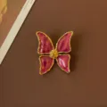Close-up of a vintage baroque butterfly brooch featuring purple enamel and gold trim details - Purple Vintage Butterfly Style
