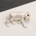 Macro detail of the realistic fur textures and black eye on this vintage silver tiger brooch. - Textured Fur Tiger Silver