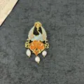 Detailed close-up of vintage enamel peacock brooch with three dangling baroque pearls - Phoenix Style