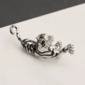 Detailed macro view of a vintage silver tiger brooch with black enamel stripes ornamentation. - Silver Black Tiger Dark Eyes