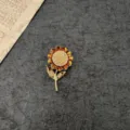 Detailed view of a vintage baroque sunflower brooch with yellow enamel and rhinestones - Sunflower Style