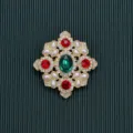 Detailed macro view of a vintage Baroque style brooch with red and green crystals and pearls - Symmetrical Red Green Gem Pearl Style / Style 4