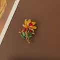 Detailed view of vintage enamel flower brooch with red gems and yellow petals - Yellow Flower with Red Gem Style
