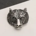 Detail showing the intricate vintage carving of the antique silver tiger head brooch - Blackened Antique Silver Tiger Head