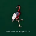 Close-up of elegant red and white enamel crane brooch with gold-tone finish - Crane Shape (BK12)