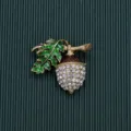 Detailed close-up showing the sparkling rhinestones and green enamel leaf of the acorn brooch - Style 5