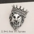 Macro detail showing a retro silver lion head brooch with a crown and rhinestones - Antique Silver Crown Lion