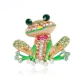 Detailed view of a funny frog brooch with colorful rhinestones and gold-tone finish - Bowtie Full Rhinestone Frog Style