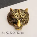 Detailed close-up view of a vintage tiger head brooch with antique gold finish texture - Realistic Tiger Head Gold