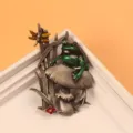Macro detail of a vintage animal frog on mushroom brooch pin with green enamel finish - Green Frog on Gray Mushroom / Green and Antique Silver
