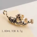 Detailed view of a vintage tiger brooch with gold finish and black enamel stripes - Leaping Tiger Gold