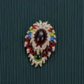 Detailed view of vintage Baroque brooch with colorful cabochons and rhinestones - Style 7
