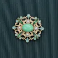 Detailed macro view of a vintage Baroque style brooch with green stones and pearls - Style 14