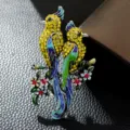 Exquisite close-up detail of a vibrant enamel bird brooch featuring yellow rhinestones - Yellow