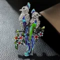 Detailed macro view of an elegant twin bird enamel brooch with sparkling rhinestone accents - Silver White