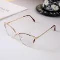 Close-up of fashionable gold cat-eye metal glasses frame with exquisite rhinestone accents - Photochromic Anti-Blue Light Lens / Red Frame