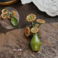 Vintage style enamel flower vase brooch with daisy details, front and pin back view - Daisy in Vase