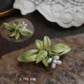 Detail showing the intricate green enamel and white berries of the vintage lily brooch - Lily of the Valley Pendant Style