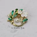Detailed view of vintage floral brooch with white enamel petals and elegant pearl drop - Green Enamel Leaf White Flower Style (BK12)