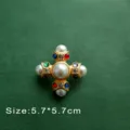 Detailed macro shot of a Baroque gold cross brooch with pearls and gems - Colorful Gem Cross Style (B12)