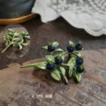 Detailed macro view of a vintage blueberry enamel brooch with size dimensions 4.3x5.8cm - Blueberry Plant Style